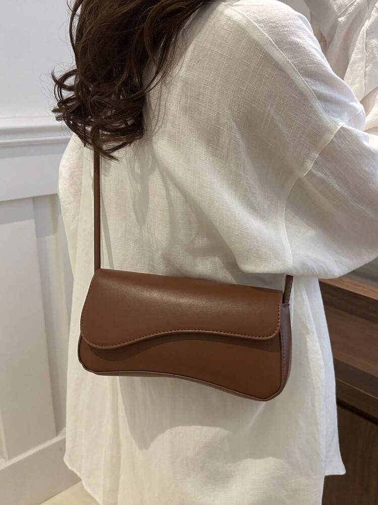 Asymmetrical flap adjustable shoulder bag in brown