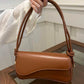Asymmetrical flap adjustable shoulder bag in brown