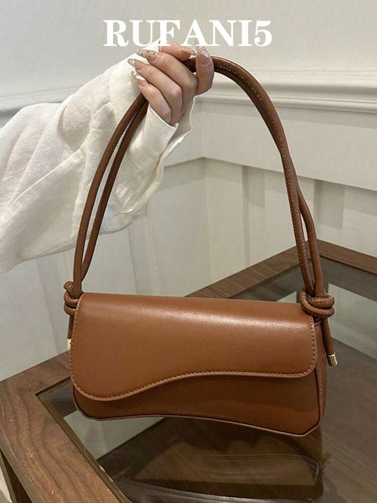 Asymmetrical flap adjustable shoulder bag in brown