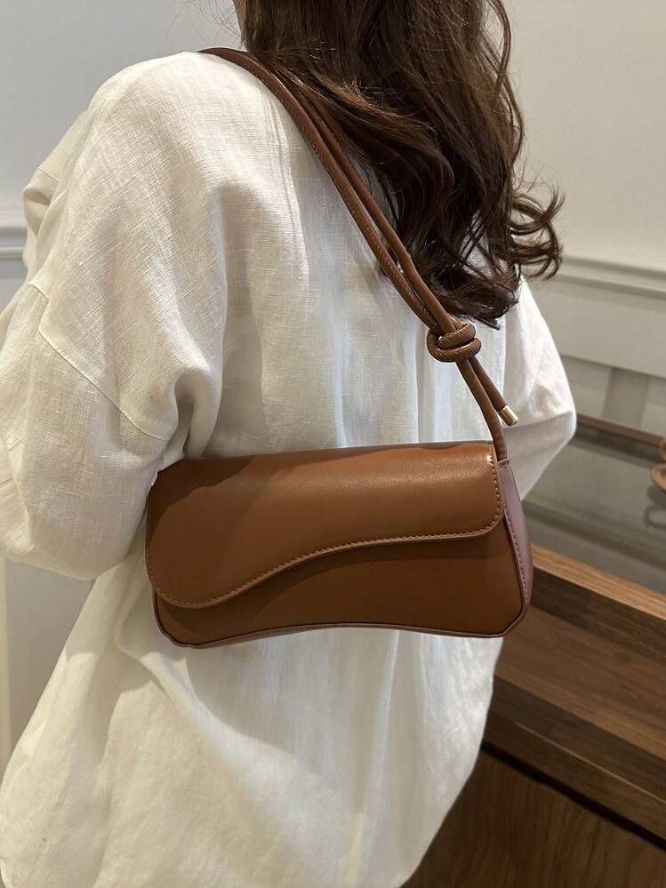 Asymmetrical flap adjustable shoulder bag in brown