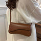Asymmetrical flap adjustable shoulder bag in brown