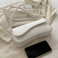 Asymmetrical flap adjustable shoulder bag in white