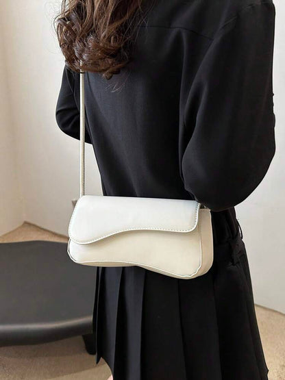 Asymmetrical flap adjustable shoulder bag in white