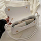 Asymmetrical flap adjustable shoulder bag in white