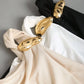 Gold decor twist asymmetric top in nude