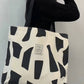 Letter graphic geometric pattern tote bag in black